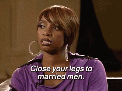 a woman is sitting on a couch and says close your legs to married men .