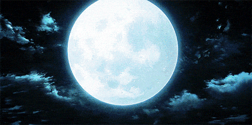 a full moon shines brightly in a cloudy night sky