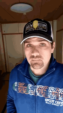a man wearing a hat that says brewtorium