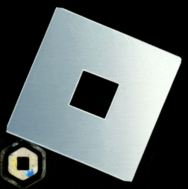 a square piece of plastic with a hole in the middle