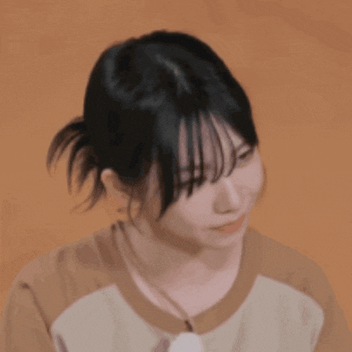 a close up of a woman 's face with a brown background