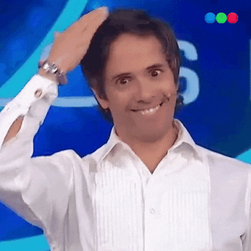 a man wearing a white shirt and a watch stands in front of a blue background with the number 6 on it