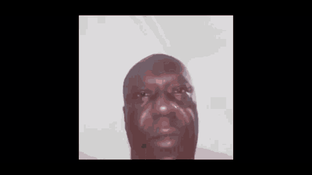 a close up of a man 's face making a funny face .