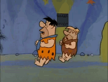 a cartoon of flintstone and benny flintstone standing next to each other in front of a cave