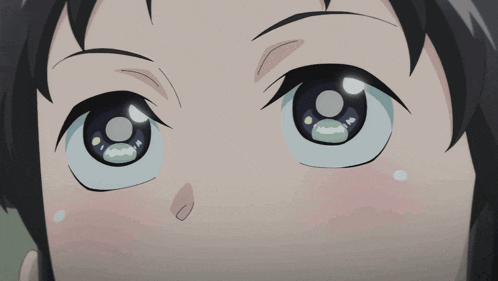 a close up of a person 's eyes with a tear coming out of them