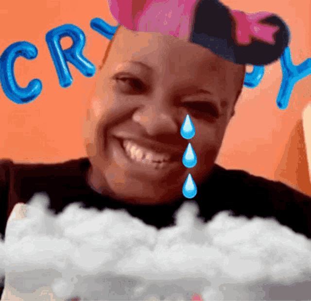 a woman with tears coming out of her eyes wearing a pink hat with the word cry on it