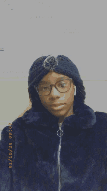 a woman wearing glasses and a black fur coat takes a picture