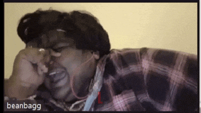a man wearing headphones and a plaid shirt is crying with beanbagg written on the bottom right