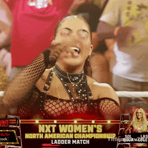 a woman is laughing in front of a screen that says next women 's north american championship ladder match
