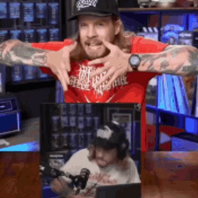 a man in a red shirt is making a face in front of a picture of another man