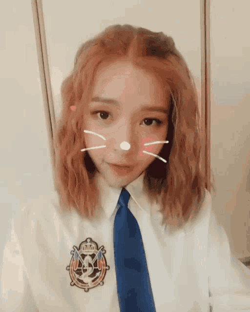 a girl with red hair is wearing a white shirt and blue tie