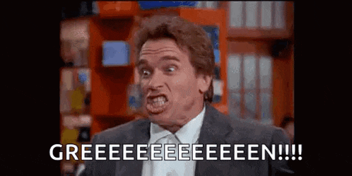 arnold schwarzenegger is making a funny face while wearing a suit and tie in a store .