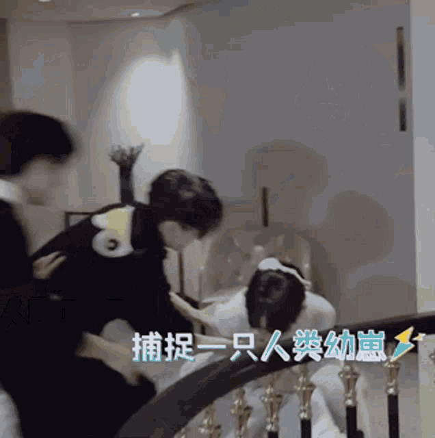 a group of people are standing on a set of stairs with chinese writing on the wall behind them .