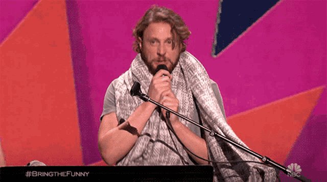 a man singing into a microphone with the hashtag #bringthefunny on the bottom