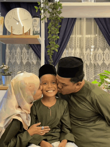 a man and a woman kiss a child on the cheek