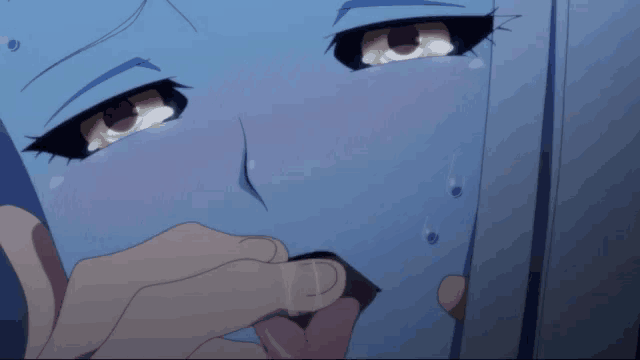 a close up of a person 's face with tears coming out of their eyes