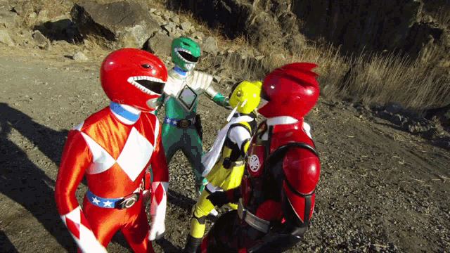a group of power rangers are standing on a gravel road