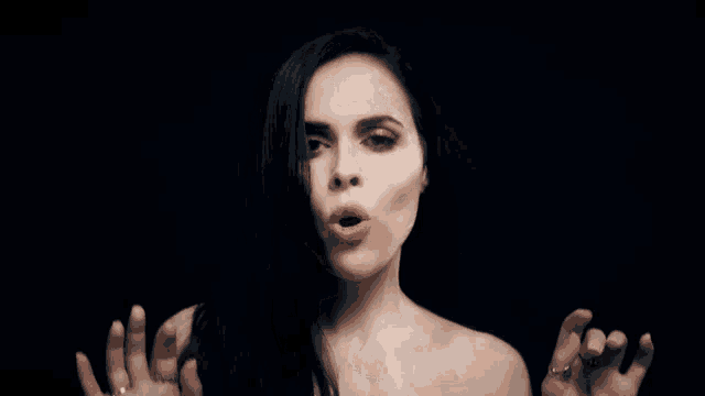 a woman without a shirt is looking at the camera
