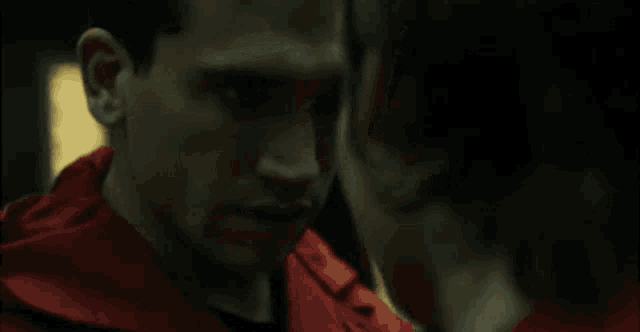 a man and a woman are kissing each other in a dark room .