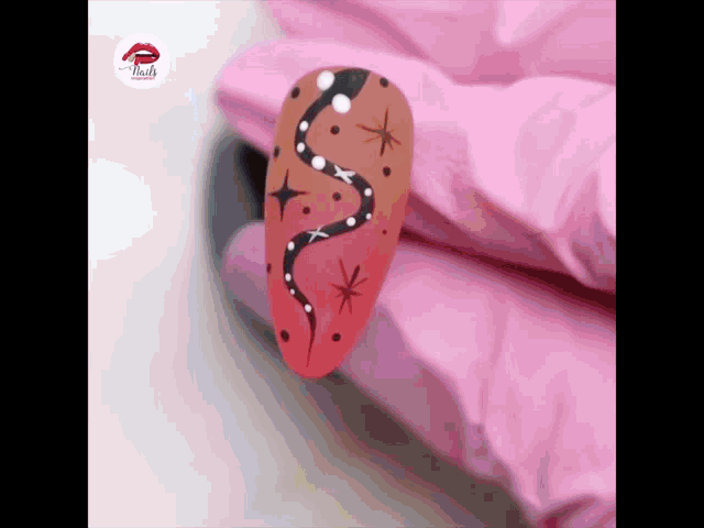 a close up of a nail with a snake and stars on it