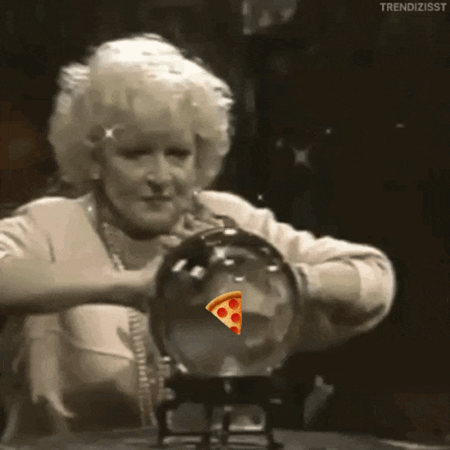 a woman is looking at a crystal ball with a slice of pizza in it