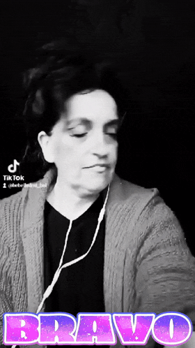 a black and white photo of a woman wearing headphones with the word bravo in the upper right corner