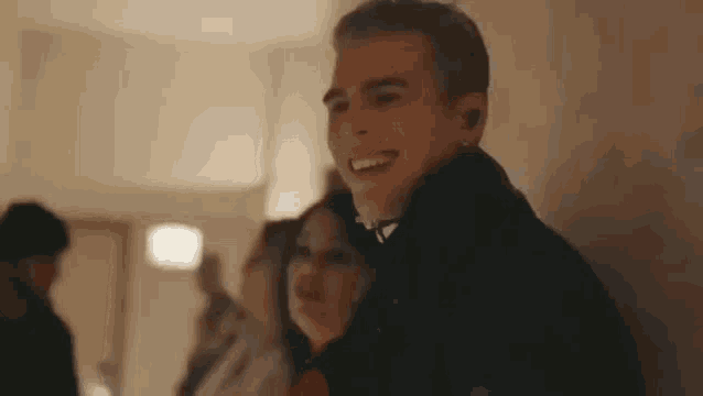 a man and a woman are standing next to each other and smiling .