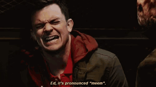 a man in a red shirt is saying " ed it 's pronounced " meem "