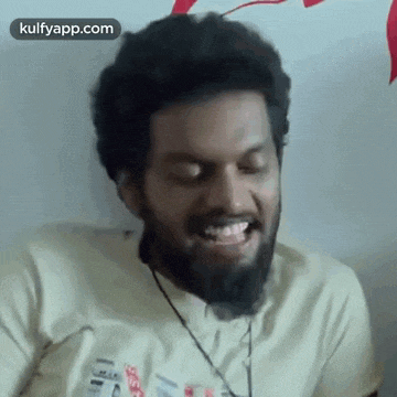 a man with a beard is making a funny face with his mouth open .