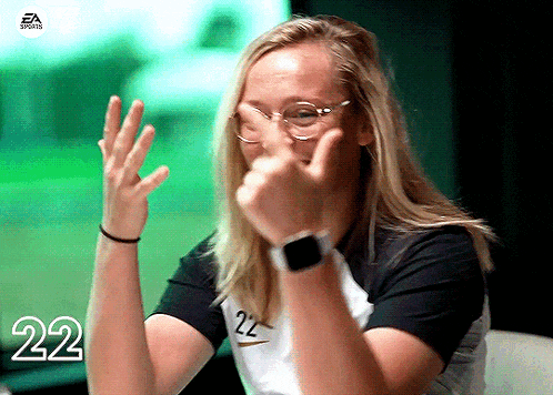 a woman wearing glasses and a black shirt with the number 22 on the front
