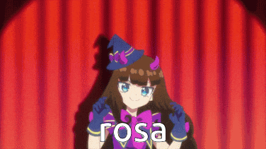 a girl in a witch costume is standing in front of a red curtain with the word rosa written on it