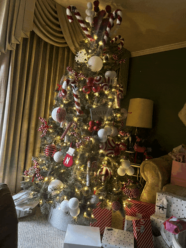 a christmas tree with candy canes and a sign that says santa claus