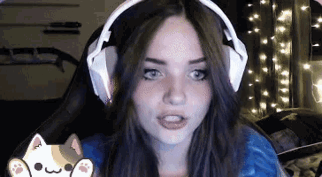 a woman wearing headphones is sitting in a chair in front of a computer screen .
