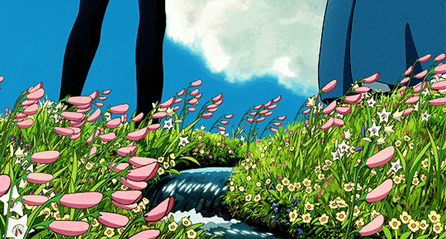 a couple of people standing in a field of pink flowers