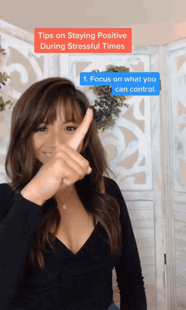 a woman is giving a thumbs up with a caption about staying positive during stressful times
