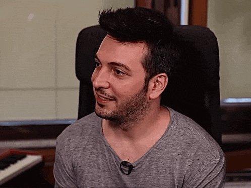 a man sitting in a chair with a microphone in his neck