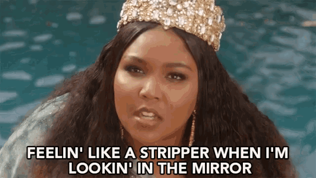 a woman wearing a crown and earrings is talking about being a stripper while looking in the mirror .
