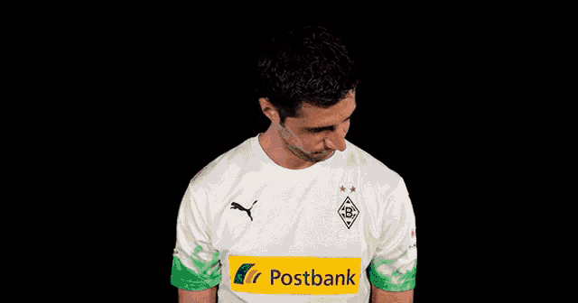 a man wearing a white shirt with a postbank logo on it