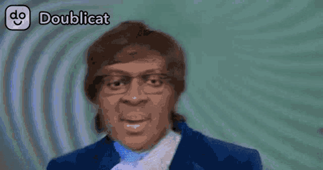 a man wearing glasses and a blue jacket with doublicat written on the bottom