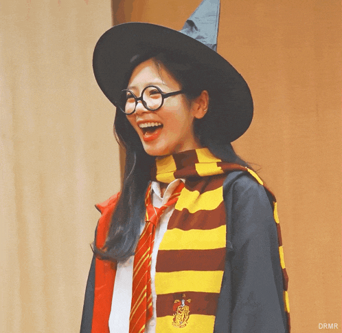 a woman in a harry potter costume with glasses and a scarf