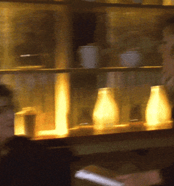 a blurry picture of a person looking at a menu in a restaurant