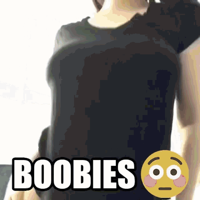 a woman 's breasts are shown in a black shirt with the words " boobies " above her