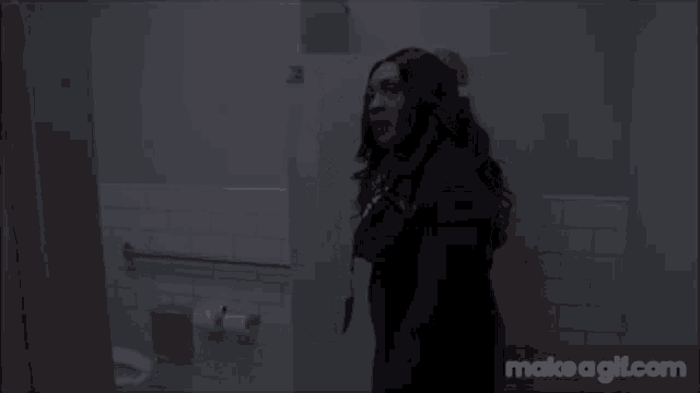 a woman is standing in a bathroom with the words " and wash your damn hands shit " on the screen