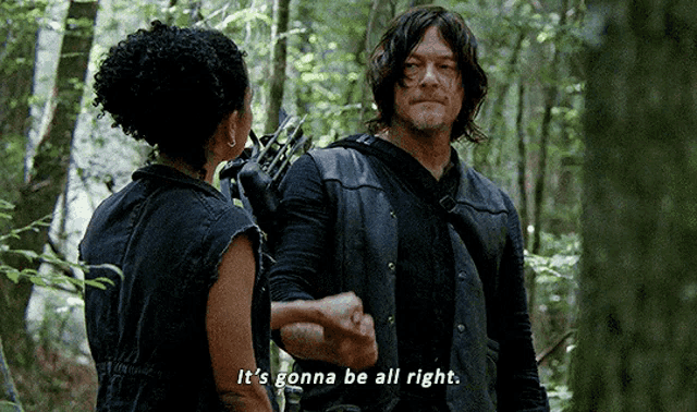 a man and a woman shaking hands in the woods with the man saying it 's gonna be all right