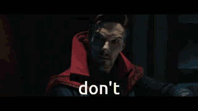 a person is holding a spider web and the word don 't is on the bottom of the screen