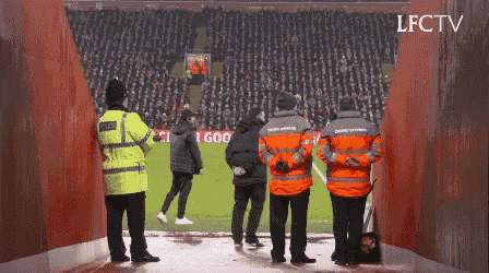 a group of people standing on a soccer field with lfctv written on the bottom