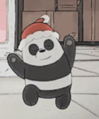 a panda bear wearing a santa hat is standing on the floor .