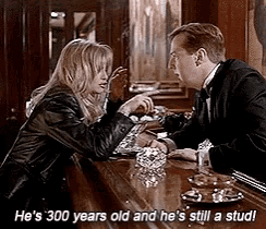 a man and a woman are sitting at a bar and the man is 300 years old and he 's still a stud