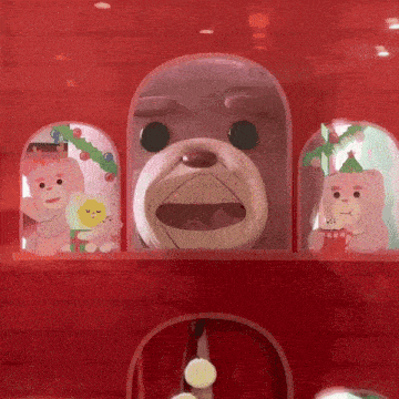 a stuffed animal in a glass dome with other stuffed animals in the background