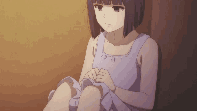 a girl in a purple dress is sitting on a wall